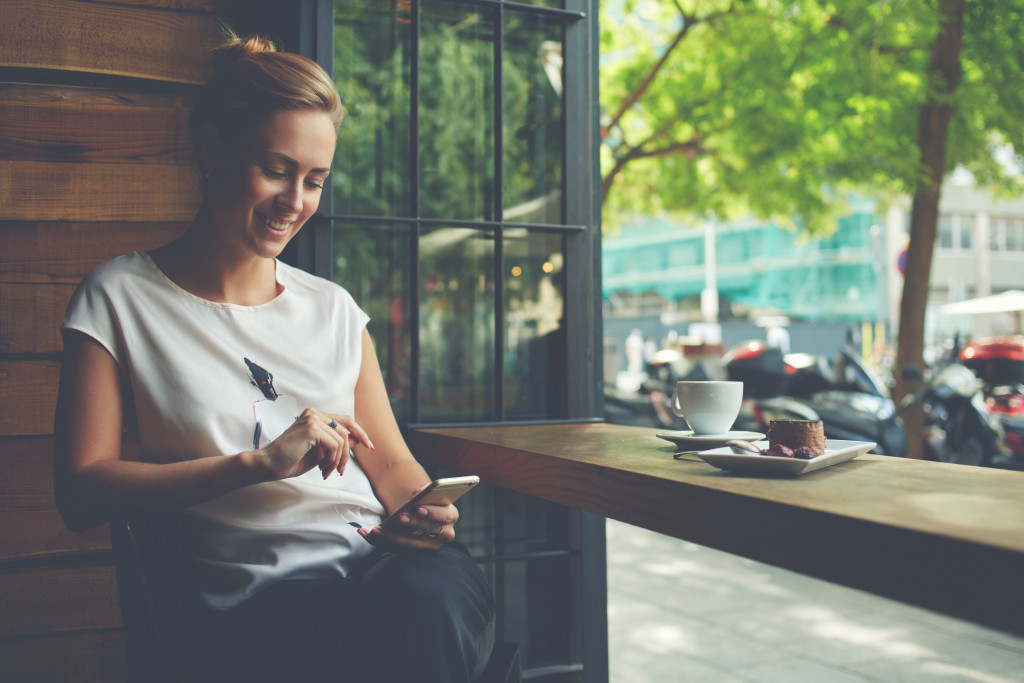 woman smiling at her phone