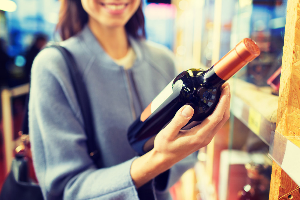 woman holding a wine bottle