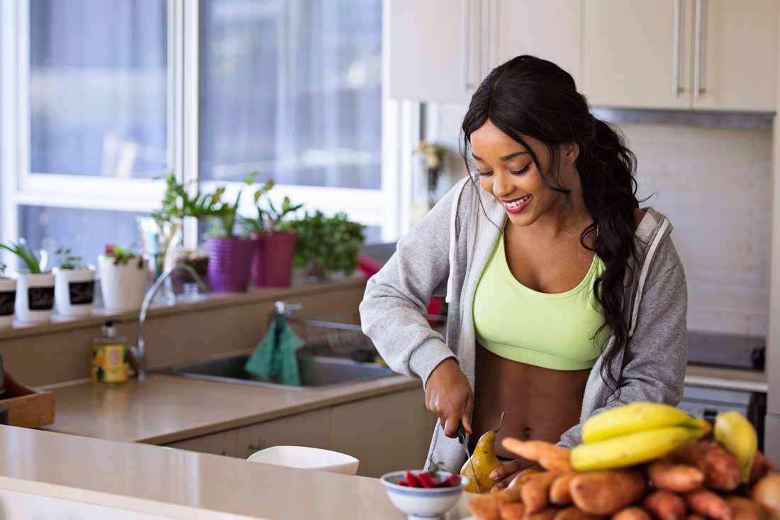 fit woman preparing meal