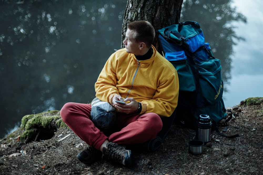 man with camping gear