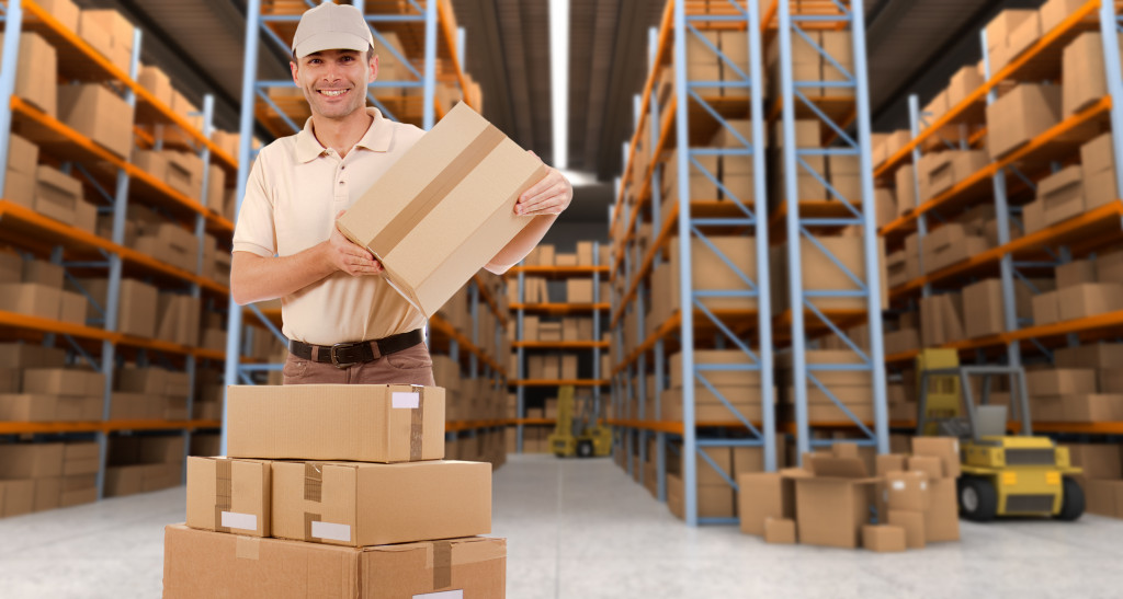 man stacking boxes in warehouse