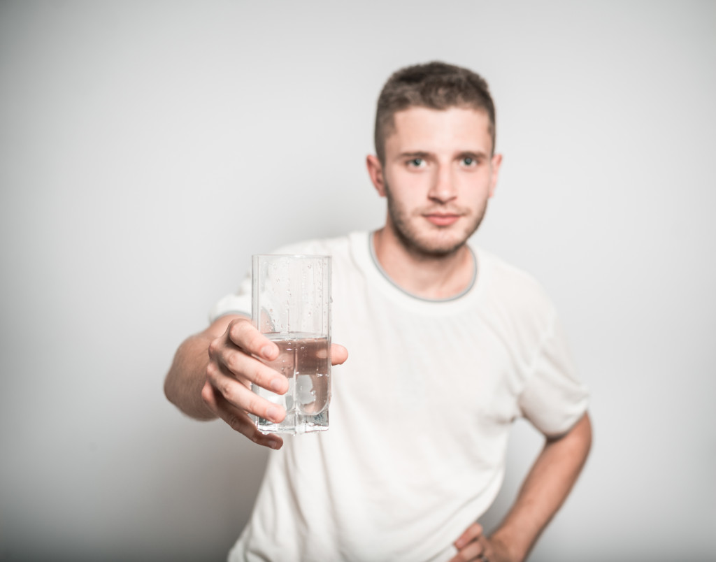 A man holding a glass of water