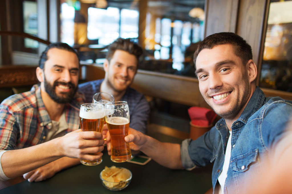 Three male friend enjoy and drinking beer 