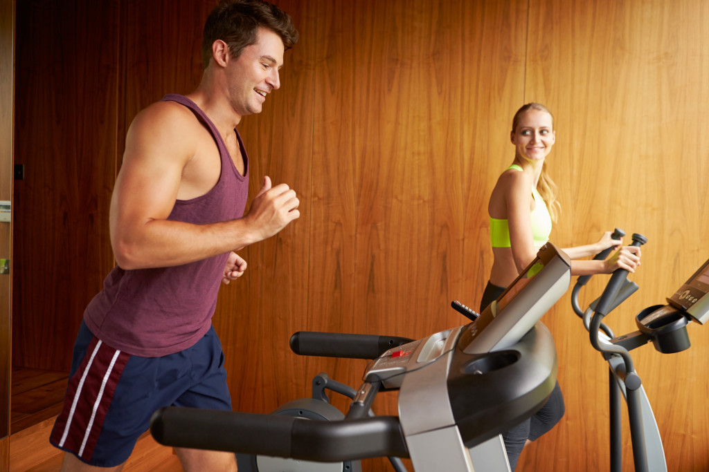 A couple exercising together in their home gym