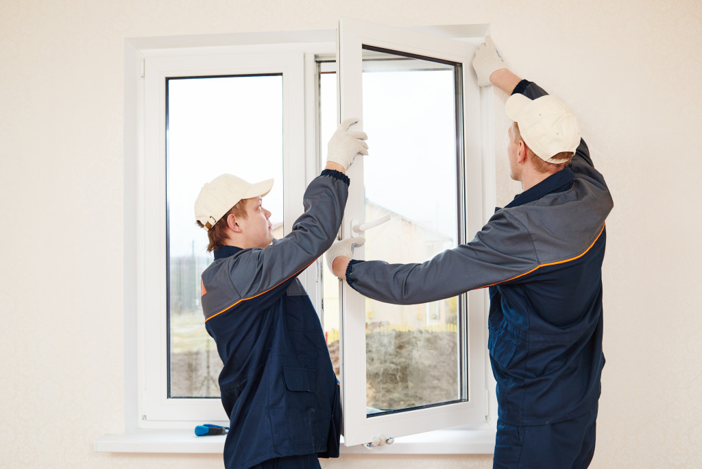 Workers installing new windows in a home