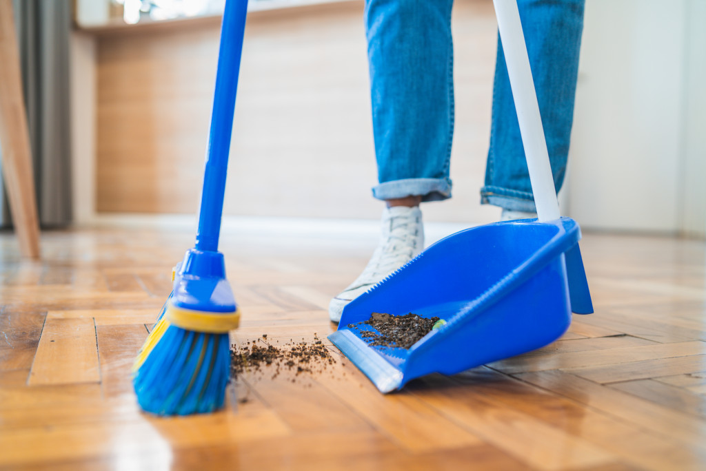 A solo homeowner sweeping the floors