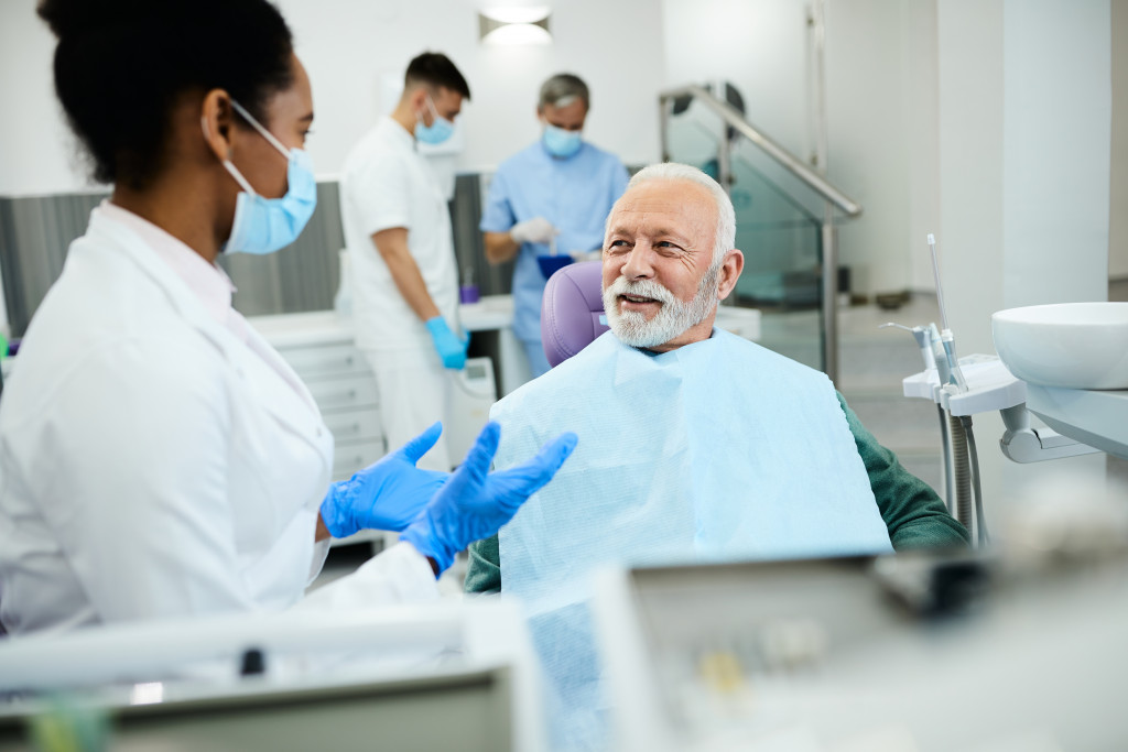 senior talking to dentist