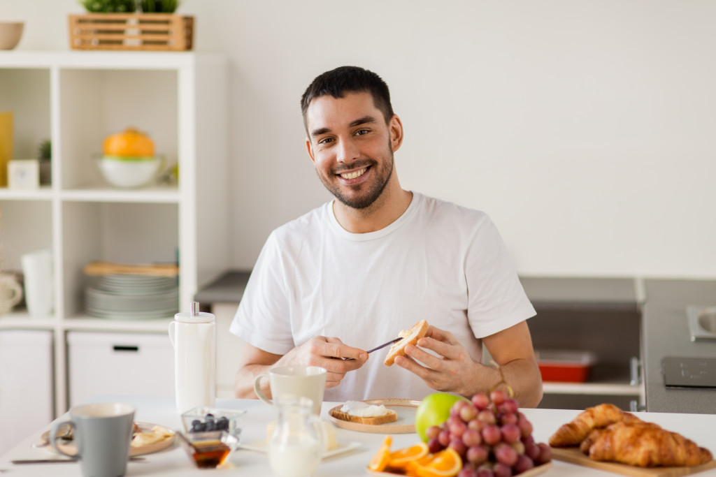 A male in the kitchen, preparing a healthy snack