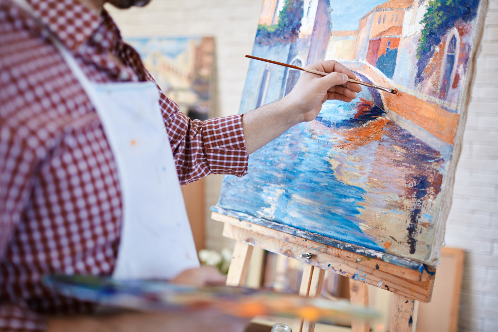 a man creating a painting for home