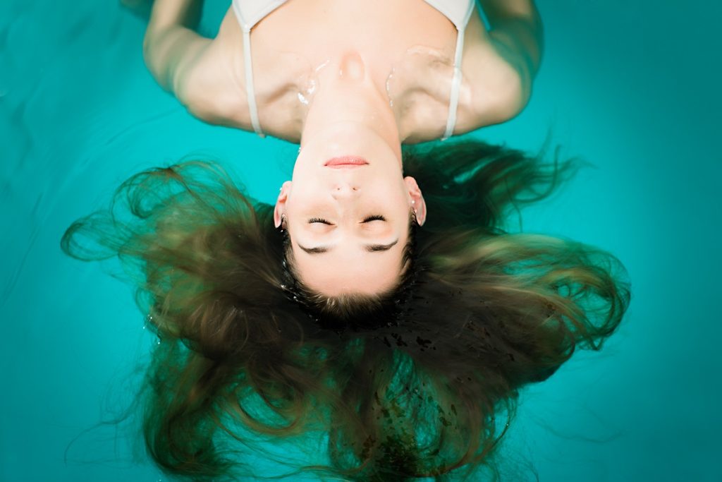 woman floating in a swimming pool