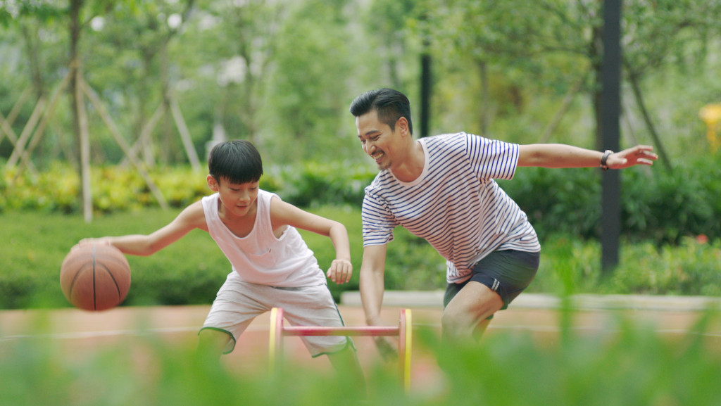 dad and son playing ball outdoors