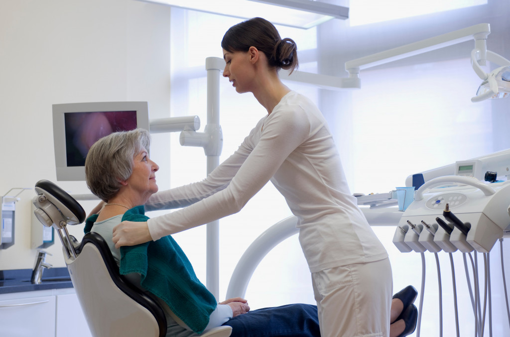 An older woman sitting on the dental chair in a clinic