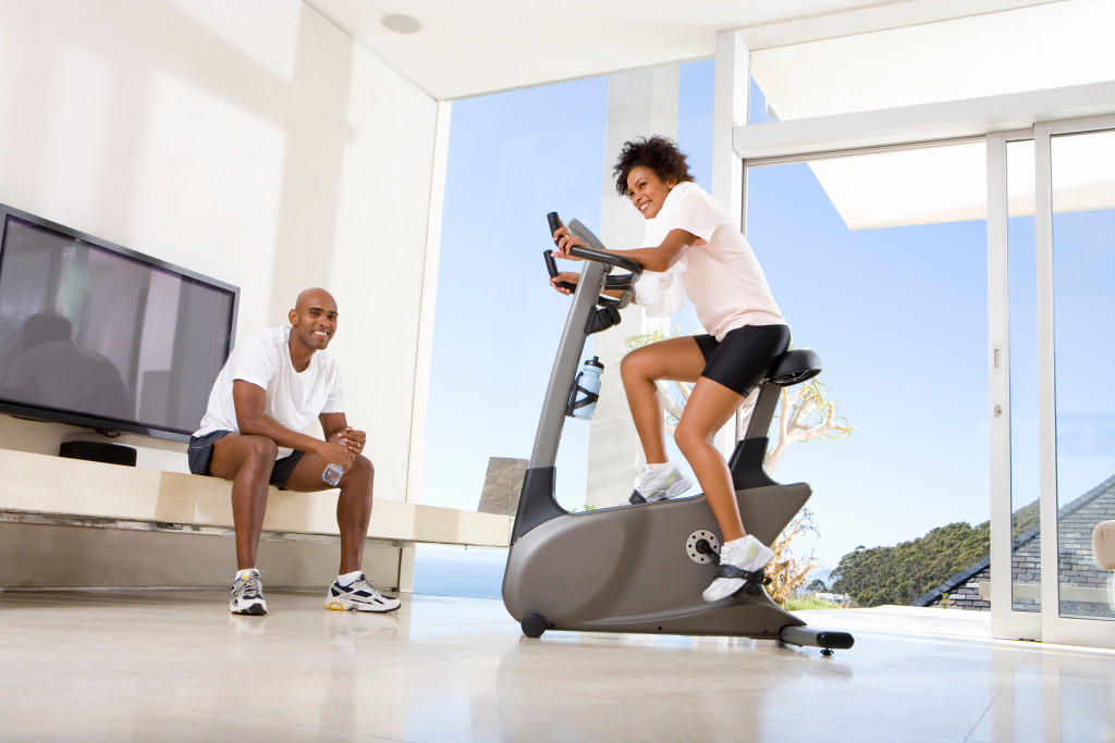 couple exercising at home with equipment