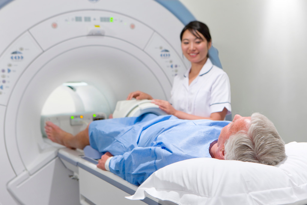  helping old man with an MRI scan