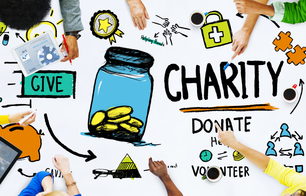 Charity donation concept with human hands around